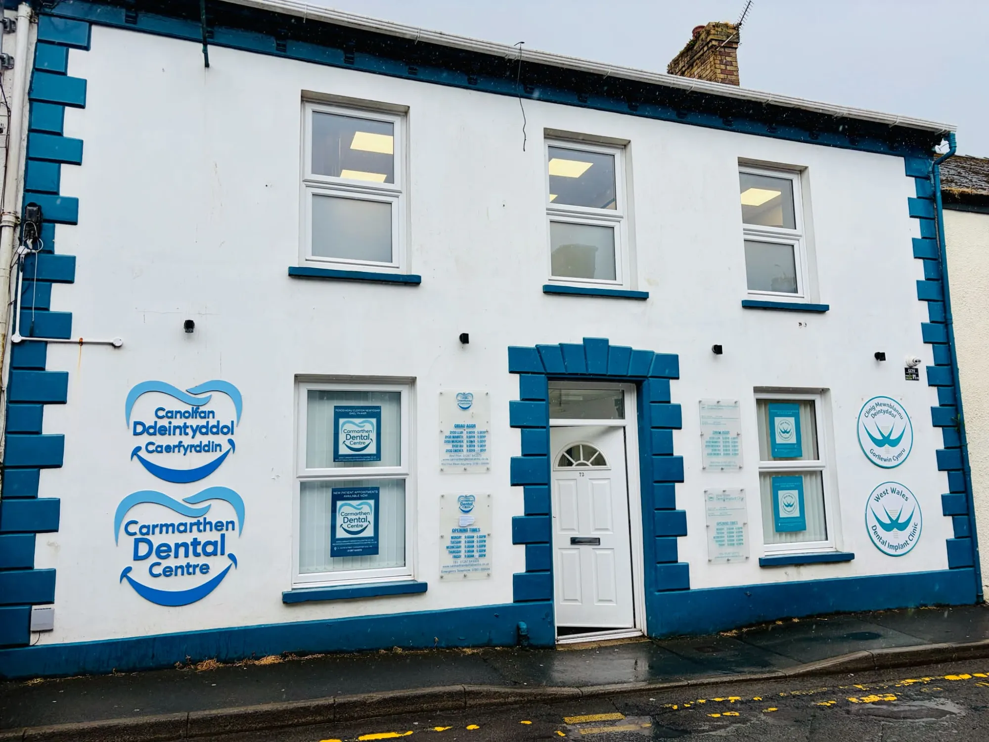 Carmarthen Dental Centre on Water Street: a white building with deep blue corner stones and the practice signs in its windows